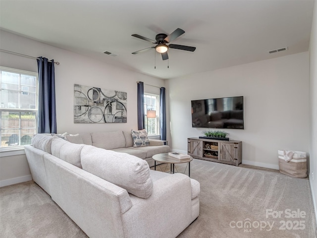 living room with ceiling fan, baseboards, visible vents, and carpet