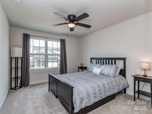 bedroom with baseboards, a ceiling fan, and light colored carpet
