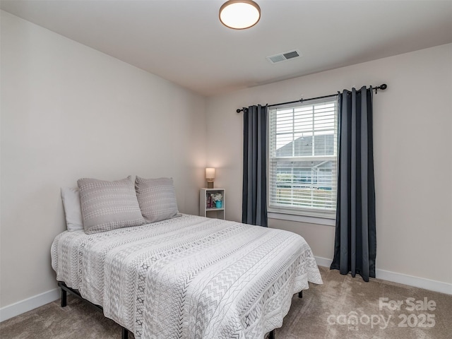bedroom with carpet, visible vents, and baseboards