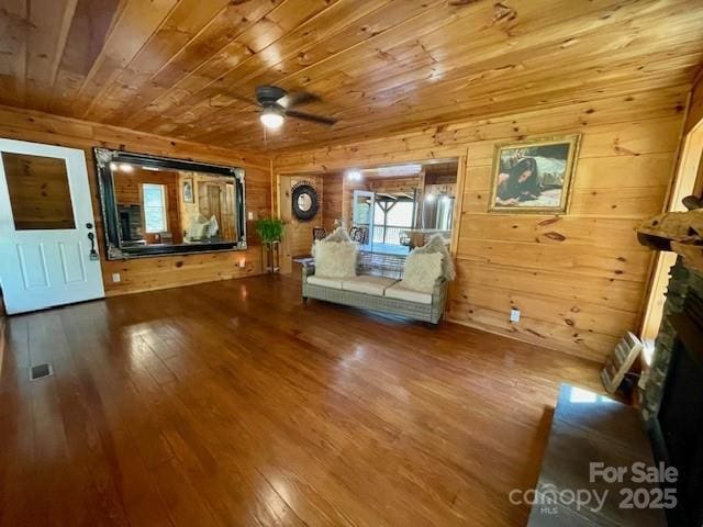 926 Cross Creek Dr, Rutherfordton, NC 28139 - living room featuring wood ceiling, a ceiling fan, hardwood / wood-style flooring, wood walls, and a stone fireplace