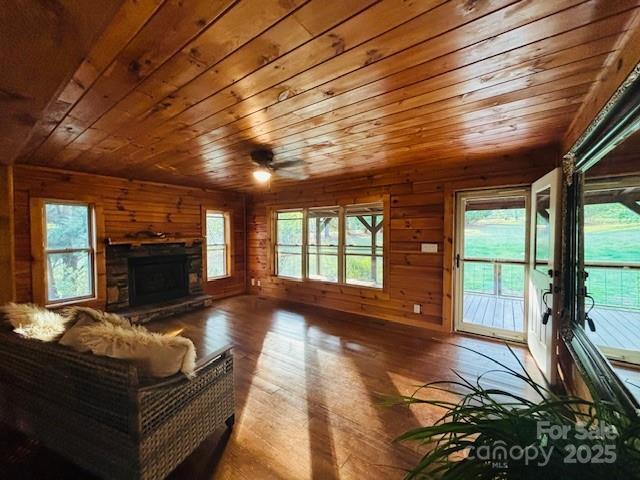 926 Cross Creek Dr, Rutherfordton, NC 28139 - living area featuring wood ceiling, hardwood / wood-style flooring, a stone fireplace, and wood walls