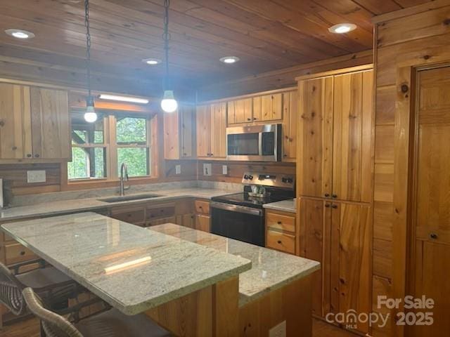 926 Cross Creek Dr, Rutherfordton, NC 28139 - kitchen featuring electric range oven, a sink, stainless steel microwave, wooden ceiling, and a kitchen bar