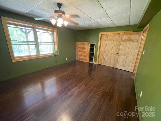 926 Cross Creek Dr, Rutherfordton, NC 28139 - unfurnished bedroom featuring wood finished floors, a closet, baseboards, ceiling fan, and a paneled ceiling