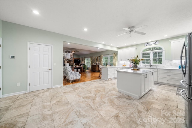 148 Broyles Rd, Hendersonville, NC 28791 - kitchen with a ceiling fan, open floor plan, freestanding refrigerator, white cabinets, and plenty of natural light