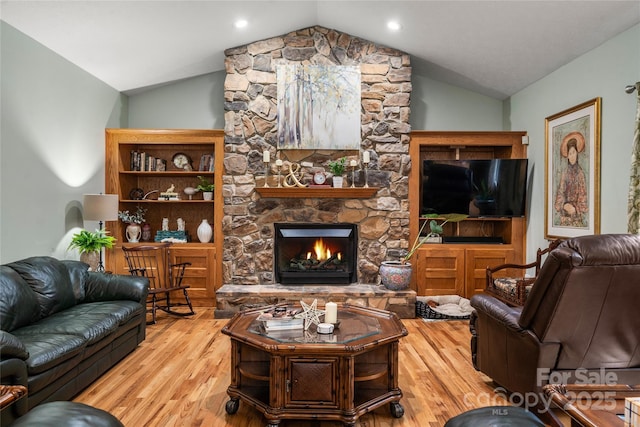 148 Broyles Rd, Hendersonville, NC 28791 - living room with vaulted ceiling, wood finished floors, and a stone fireplace