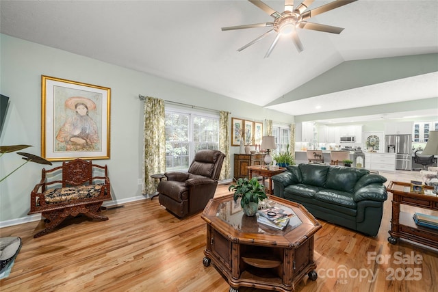 148 Broyles Rd, Hendersonville, NC 28791 - living area featuring a ceiling fan, vaulted ceiling, light wood-style floors, and baseboards