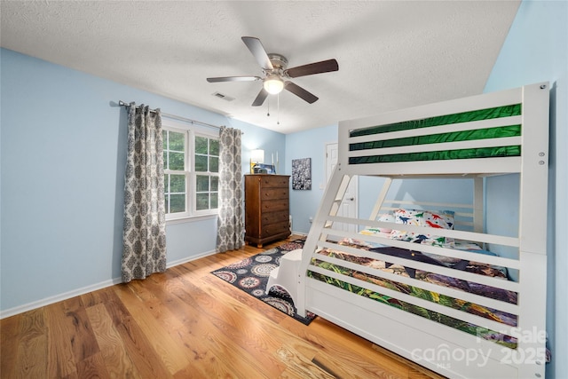148 Broyles Rd, Hendersonville, NC 28791 - bedroom with a textured ceiling, wood finished floors, baseboards, and a ceiling fan