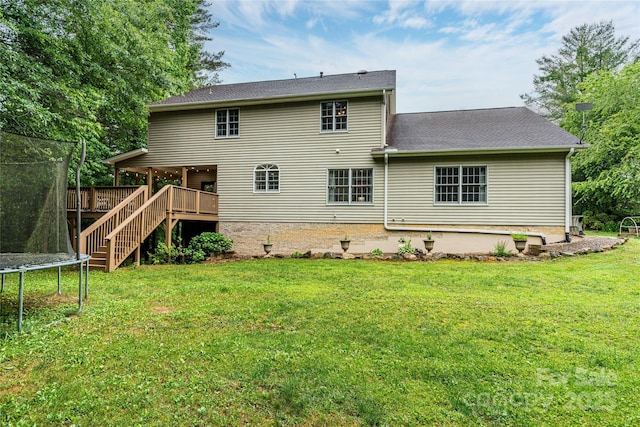 148 Broyles Rd, Hendersonville, NC 28791 - back of house featuring a trampoline, a lawn, a deck, stairs, and roof with shingles
