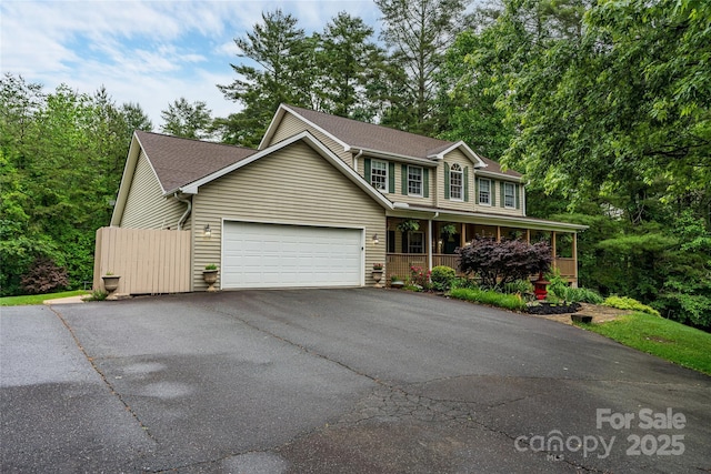 148 Broyles Rd, Hendersonville, NC 28791 - view of front facade featuring a porch, asphalt driveway, a garage, and roof with shingles