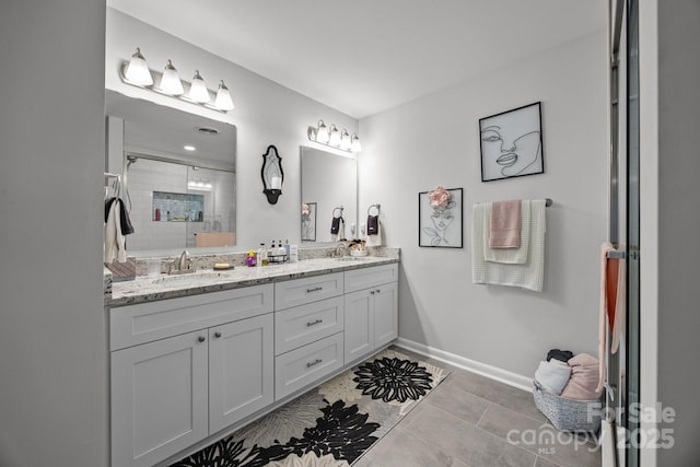 130 Cherokee Ln, Salisbury, NC 28147 - bathroom featuring double vanity, a tile shower, baseboards, and tile patterned flooring