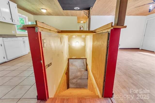 staircase featuring wood finished floors and wooden ceiling