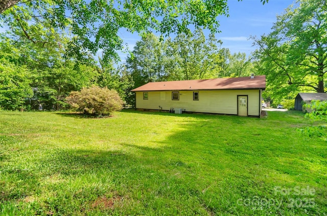 back of house with a lawn