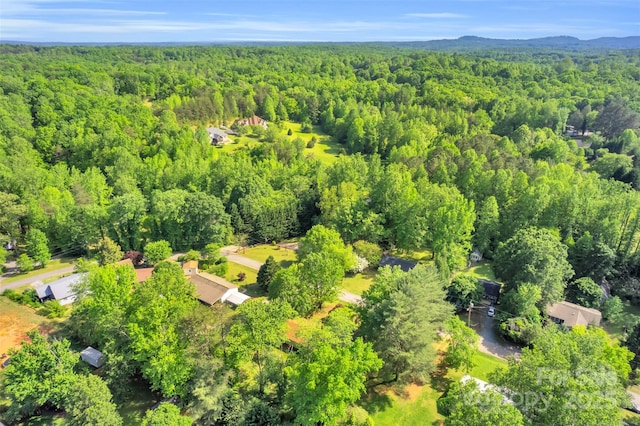 birds eye view of property with a wooded view