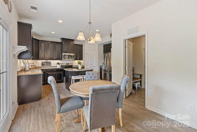 176 Jennymarie Rd, Mooresville, NC 28115 - dining room with a chandelier, light wood finished floors, baseboards, and recessed lighting