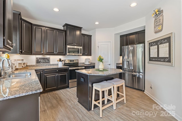 176 Jennymarie Rd, Mooresville, NC 28115 - kitchen with stainless steel appliances, a sink, a center island, light stone countertops, and a kitchen breakfast bar