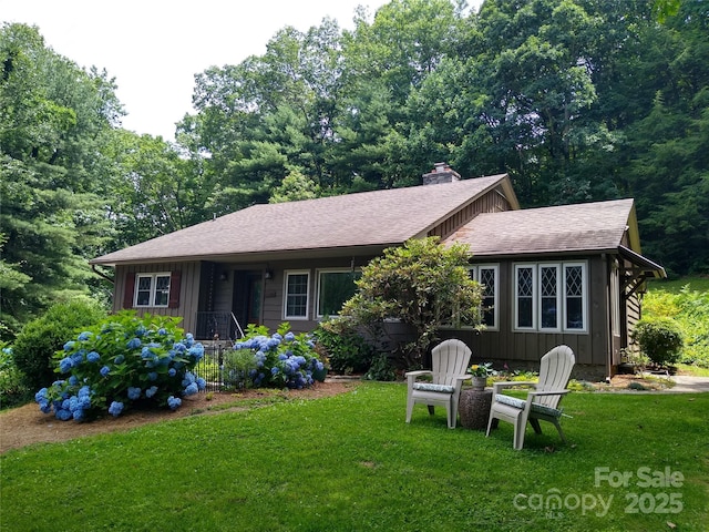 242 Birch Ln, Arden, NC 28704 - view of front of home with a front lawn, a chimney, roof with shingles, and board and batten siding