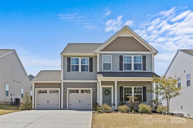 view of front of house with driveway, central AC unit, an attached garage, a front yard, and roof with shingles