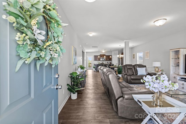 living area featuring dark wood finished floors and baseboards