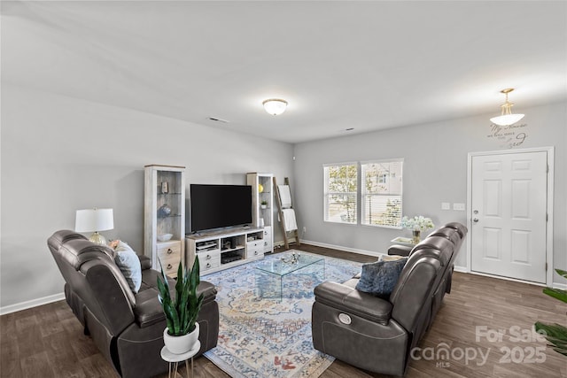 living area with wood finished floors and baseboards