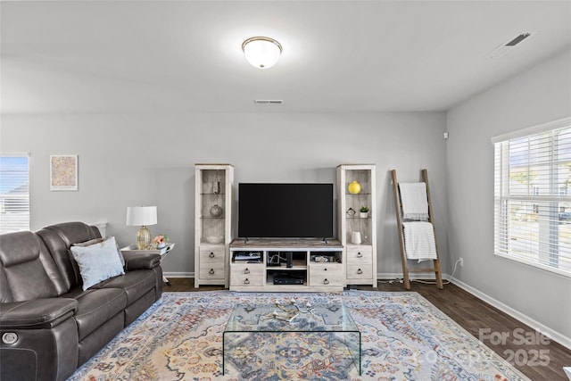 living area featuring baseboards and wood finished floors