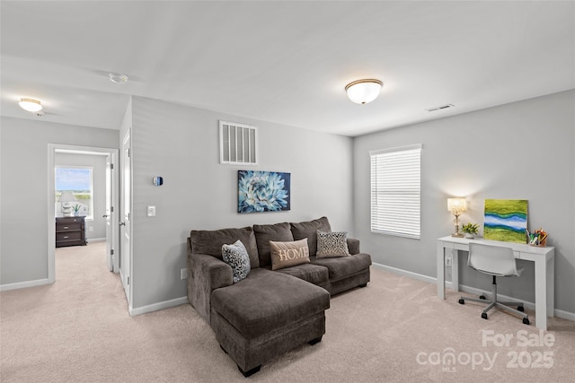 living room with light colored carpet, baseboards, and an office area
