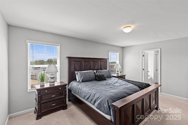 bedroom with light carpet and baseboards