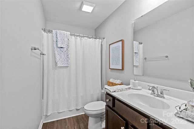 full bath with toilet, vanity, wood finished floors, and shower / bath combination with curtain