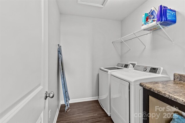 clothes washing area with washer and dryer, dark wood-style floors, baseboards, and attic access