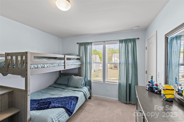 bedroom featuring light carpet and baseboards