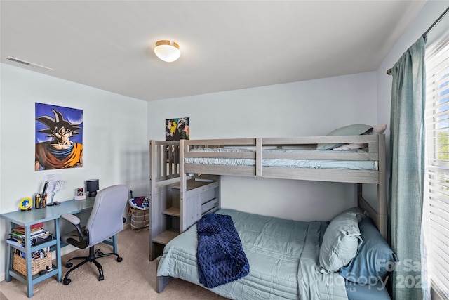 carpeted bedroom with an office area