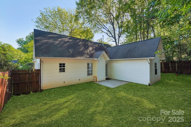9200 Forest Green Dr, Charlotte, NC 28227 - back of property featuring a lawn, a fenced backyard, and roof with shingles