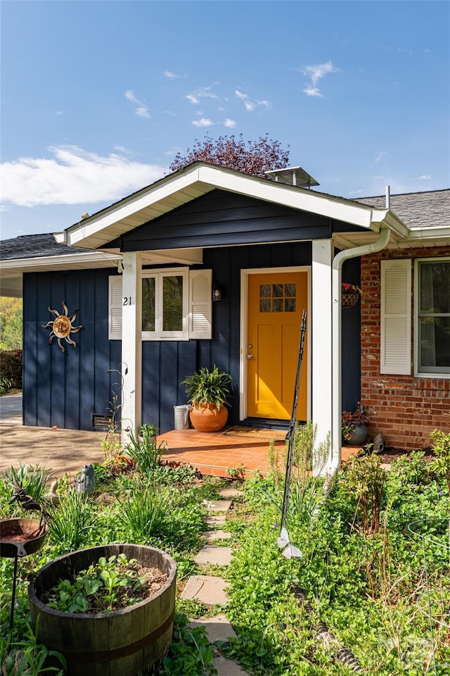 view of front of house featuring board and batten siding and brick siding