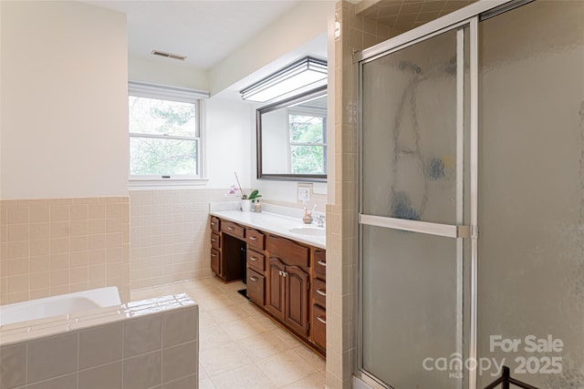 full bath with a garden tub, vanity, tile patterned floors, and a stall shower