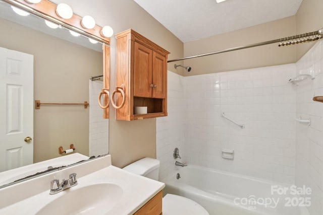 bathroom featuring vanity, toilet, and shower / washtub combination