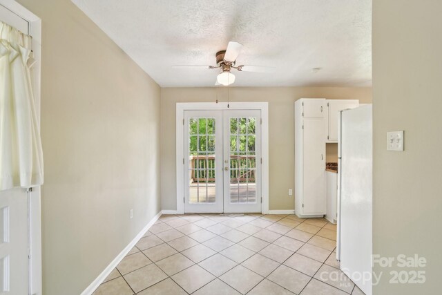 doorway to outside with light tile patterned flooring, baseboards, a textured ceiling, french doors, and a ceiling fan