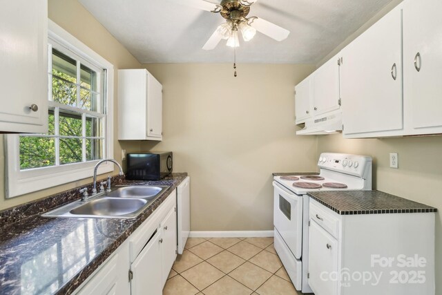 kitchen featuring black microwave, dark countertops, white range with electric cooktop, under cabinet range hood, and a sink