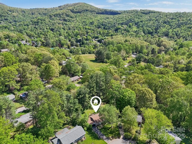 drone / aerial view with a wooded view