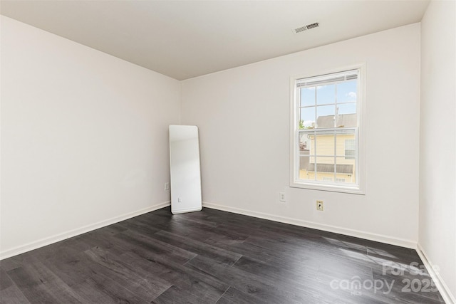 8424 Spirea Ct, Charlotte, NC 28215 - unfurnished room with dark wood-style flooring, visible vents, and baseboards