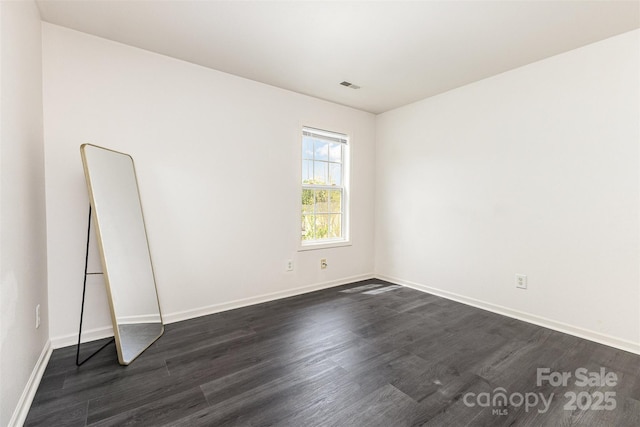 8424 Spirea Ct, Charlotte, NC 28215 - unfurnished room featuring visible vents, baseboards, and dark wood finished floors