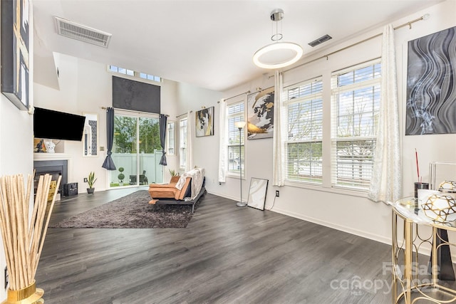8424 Spirea Ct, Charlotte, NC 28215 - living area featuring a fireplace, wood finished floors, visible vents, and plenty of natural light