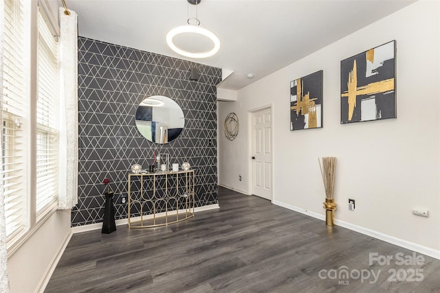 8424 Spirea Ct, Charlotte, NC 28215 - unfurnished dining area with an accent wall, wood finished floors, and baseboards