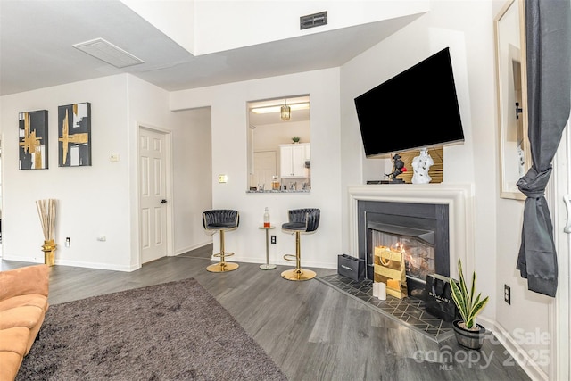 8424 Spirea Ct, Charlotte, NC 28215 - living room featuring baseboards, wood finished floors, and a glass covered fireplace