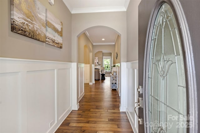 505 Chamberlain Ct, Mcadenville, NC 28101 - corridor with ornamental molding, a decorative wall, dark wood-type flooring, a wainscoted wall, and arched walkways