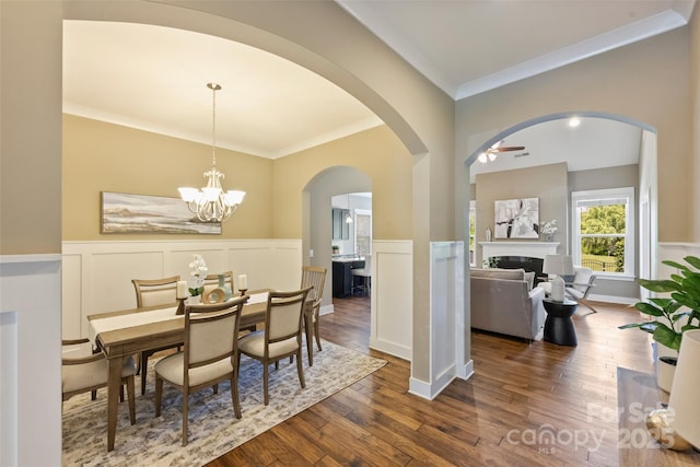 505 Chamberlain Ct, Mcadenville, NC 28101 - dining room featuring crown molding, dark wood finished floors, a wainscoted wall, and a fireplace