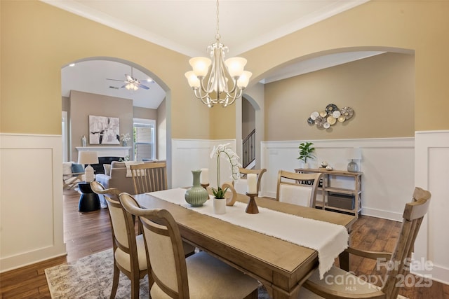 505 Chamberlain Ct, Mcadenville, NC 28101 - dining space featuring wood finished floors, arched walkways, ceiling fan with notable chandelier, and a wainscoted wall