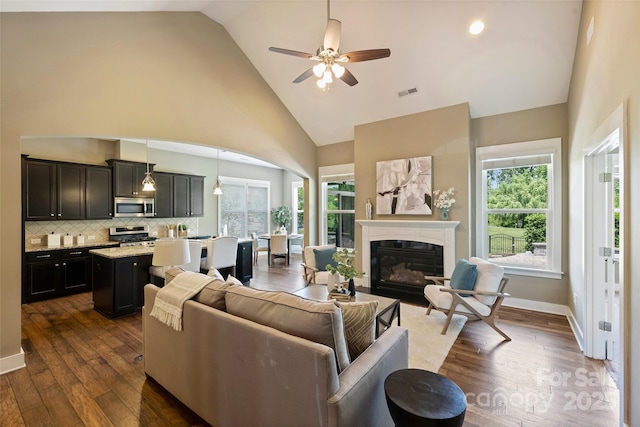 505 Chamberlain Ct, Mcadenville, NC 28101 - living area featuring a ceiling fan, visible vents, a glass covered fireplace, and dark wood-type flooring