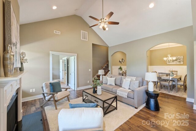 505 Chamberlain Ct, Mcadenville, NC 28101 - living room featuring arched walkways, high vaulted ceiling, visible vents, and ceiling fan with notable chandelier