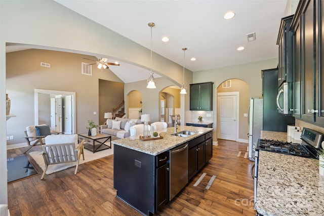 505 Chamberlain Ct, Mcadenville, NC 28101 - kitchen with a sink, arched walkways, dark wood finished floors, stainless steel appliances, and visible vents