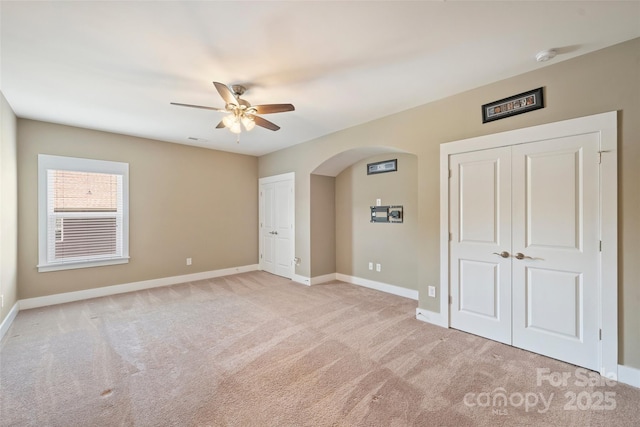 505 Chamberlain Ct, Mcadenville, NC 28101 - unfurnished bedroom featuring arched walkways, baseboards, light carpet, and two closets