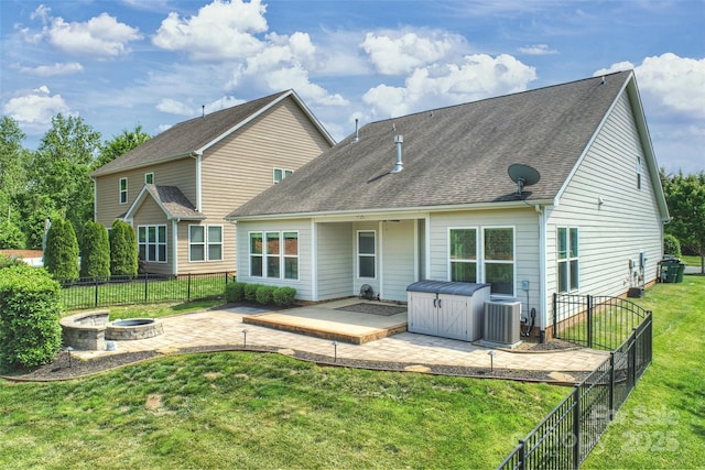 505 Chamberlain Ct, Mcadenville, NC 28101 - rear view of house with central AC, a fenced backyard, a lawn, a patio, and a fire pit